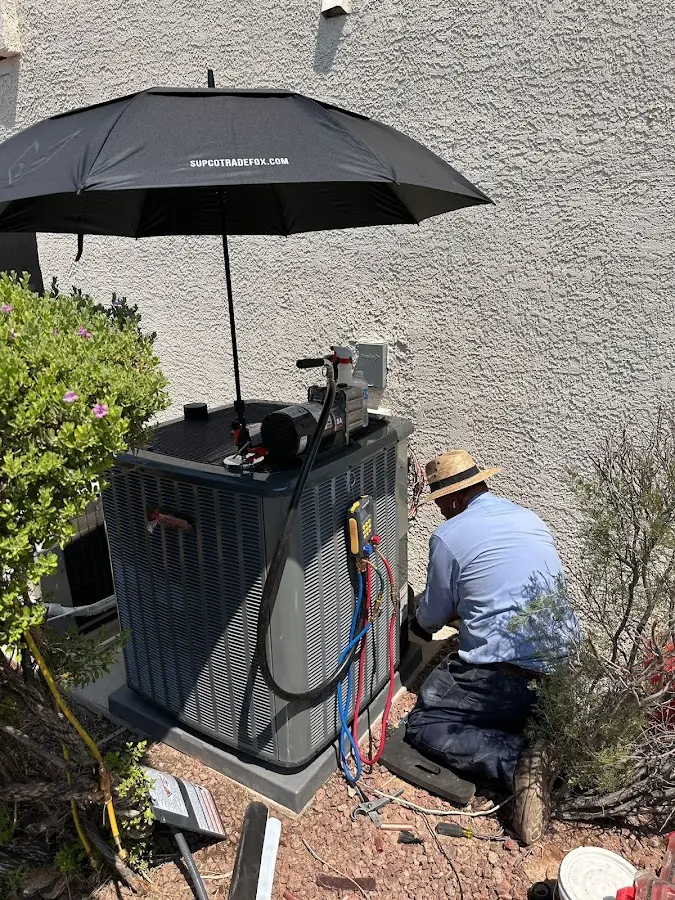 HVAC technician performing outdoor AC maintenance in Shamong
