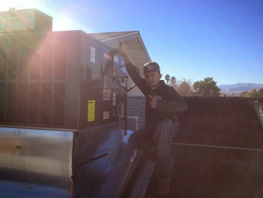 HVAC technician performing Air Duct Repair on a rooftop unit in Shamong